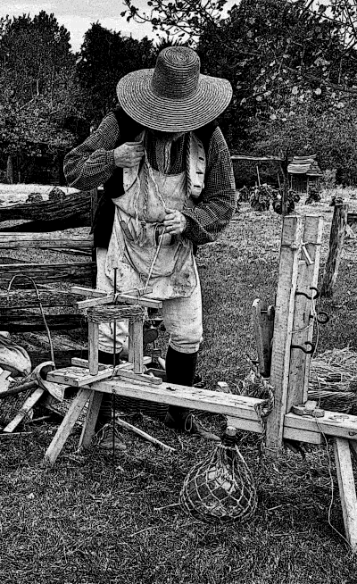 A Colonial ropemaker making rope.